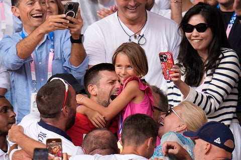 Serbia's Novak Djokovic embraces his daughter Tara after defeating Spain's Carlos Alcaraz